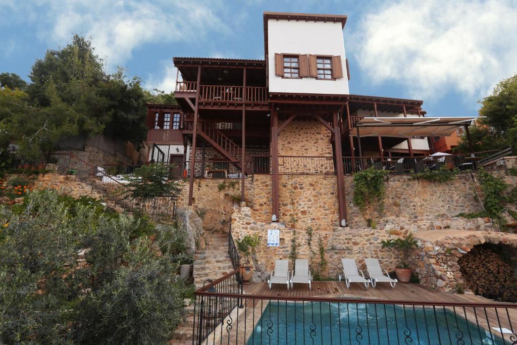 a house with a swimming pool in front of a building at Hotel Villa Turka in Alanya