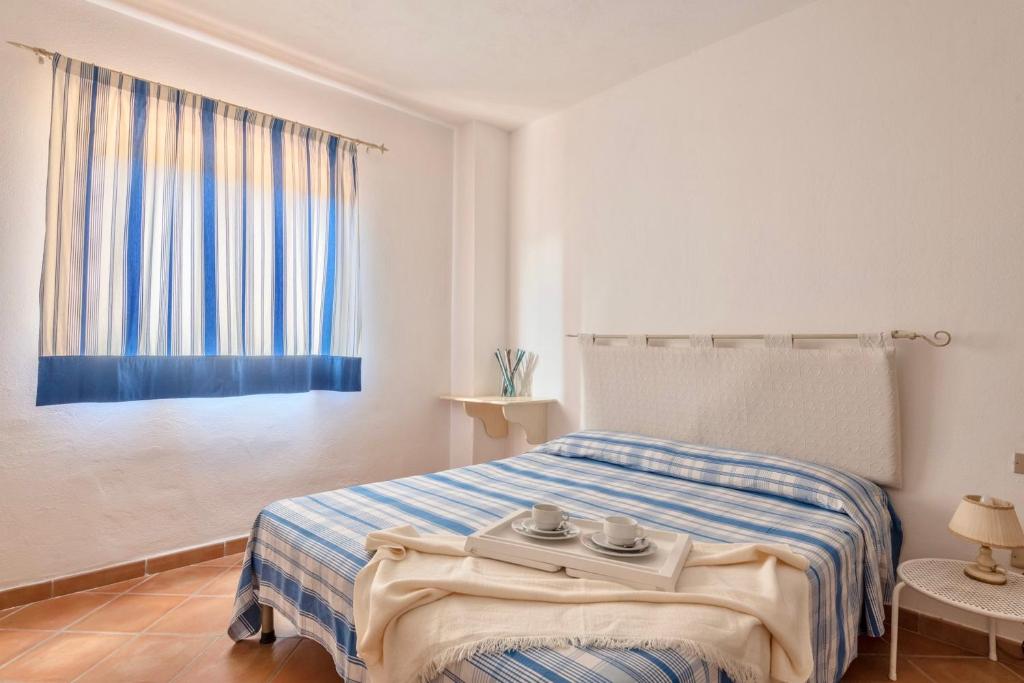 Posteľ alebo postele v izbe v ubytovaní Residence a Golfo di Marinella a 450 mt dal mare