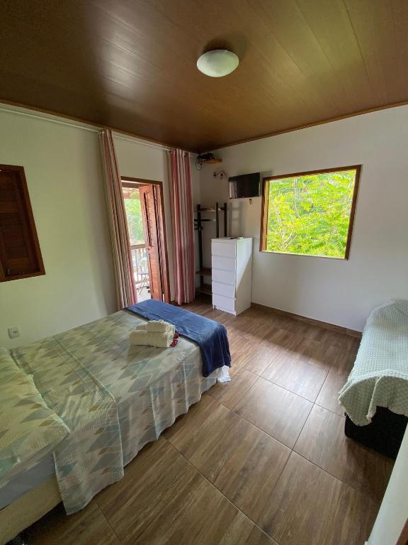 Ένα ή περισσότερα κρεβάτια σε δωμάτιο στο Agradável Kitnet próximo à Praia do Forte