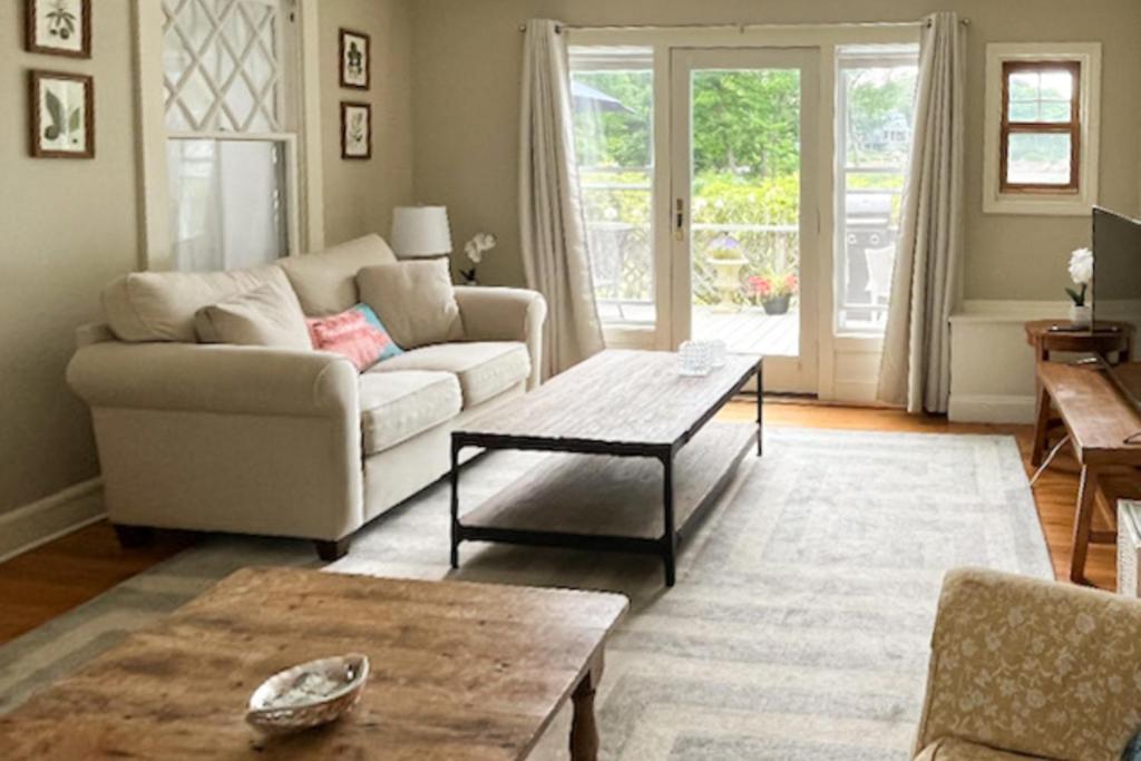 a living room with a couch and a coffee table at Black Cove Cottage in Manchester