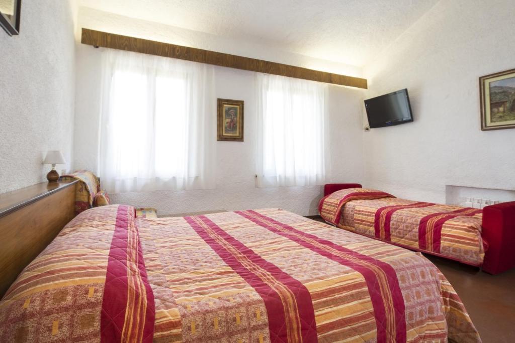 Postel nebo postele na pokoji v ubytování Hotel Rifugio Prategiano