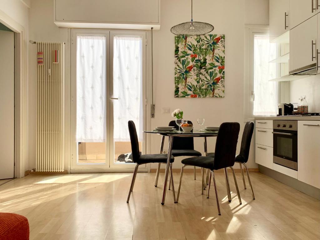a kitchen with a table and chairs in a room at Cozy apartment Tortona Navigli in Milan