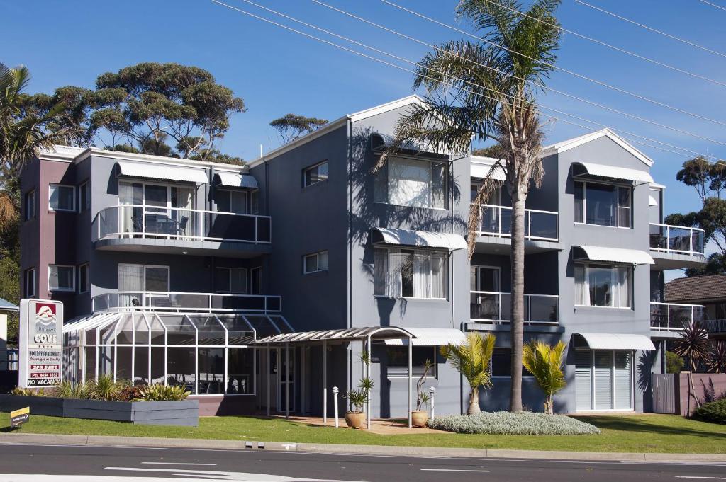 an apartment building on the corner of a street at Mollymook Cove Apartments in Mollymook