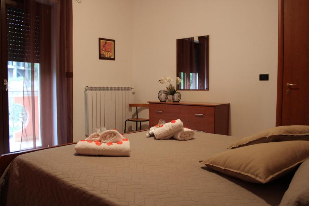 a bedroom with a bed with two stuffed animals on it at Contedoro Living in Ariano Irpino
