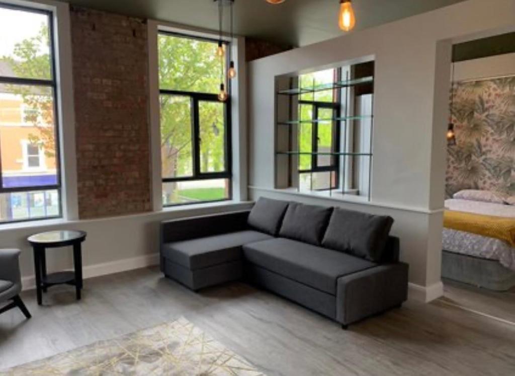 a living room with a couch and some windows at Clanbrassill loft in Dundalk