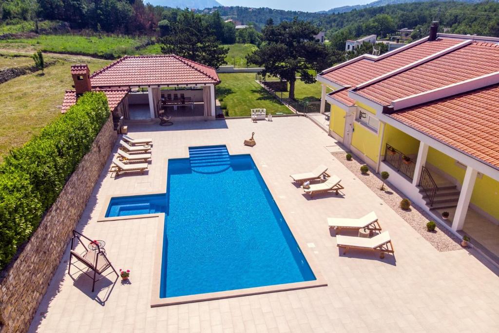 an overhead view of a swimming pool next to a house at Villa Delmati in Tugare