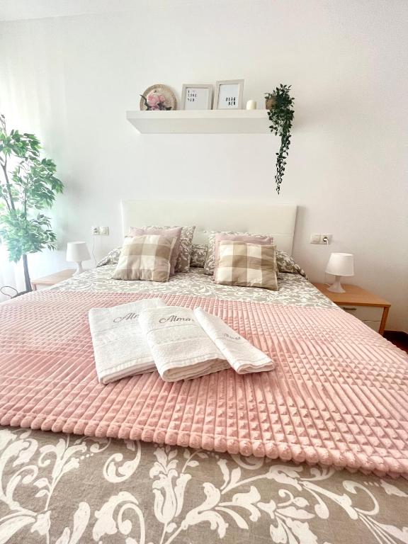 a bedroom with a bed with two towels on it at Almar II - Padrón in Padrón