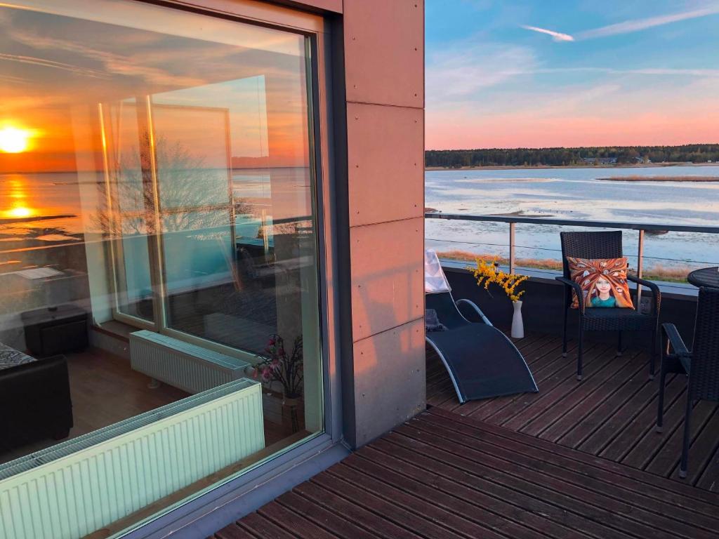 a balcony of a house with a view of the water at Sunset Dream Apartment with a panoramic seaview in Haapsalu
