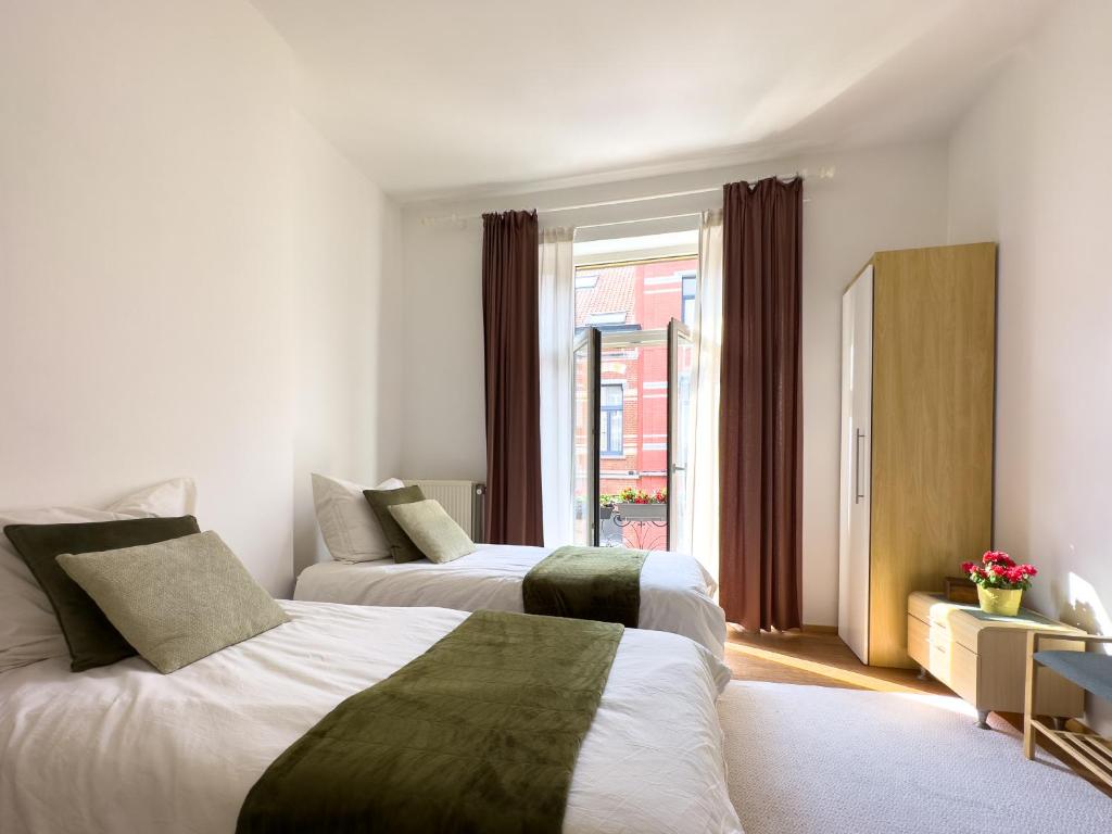 Postel nebo postele na pokoji v ubytování Ambiorix Residence