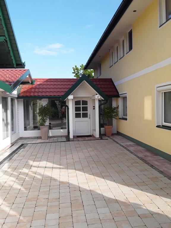 a house with a red roof at Landhaus Yvita in Feistritz ob Bleiburg