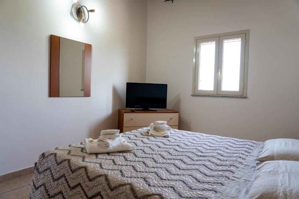 Postel nebo postele na pokoji v ubytování B&B L'Uliveto Rooms & Pool