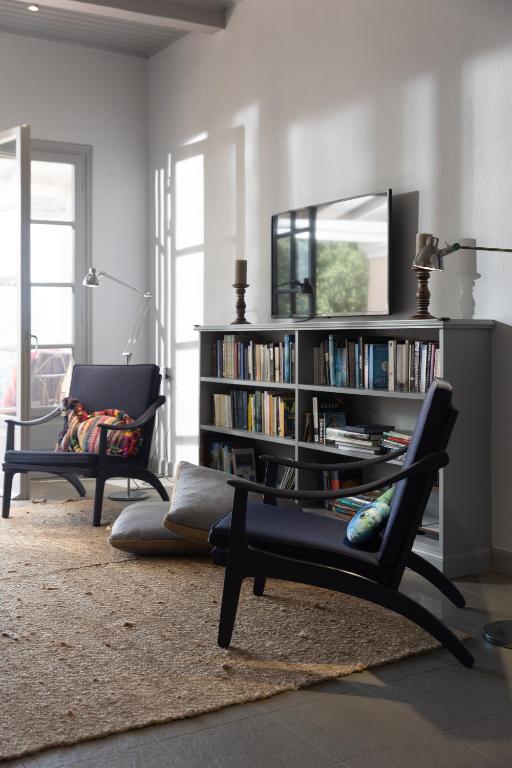 a living room with a book shelf filled with books at Paleokastritsa Red Gate Flat in Paleokastritsa