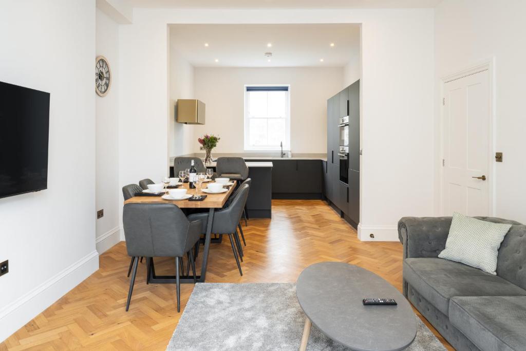 a living room with a table and a couch at Luxury home by the harbour in Ilfracombe