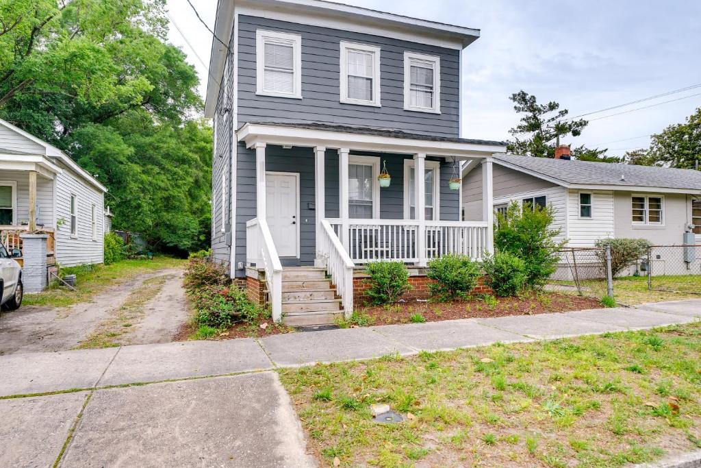 a black house with a porch and a driveway at Wilmington Getaway Near Riverwalk and Downtown! in Wilmington