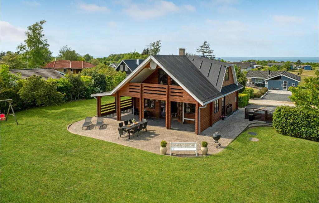 a large wooden house with a roof at Amazing Home In Glesborg With 5 Bedrooms, Sauna And Wifi in Tvedhuse