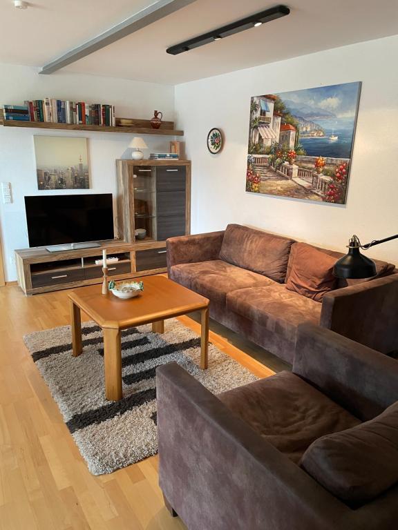 a living room with a couch and a coffee table at Ferienwohnung Meridiana in Tuntenhausen