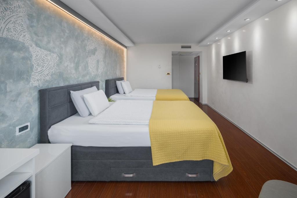 Postel nebo postele na pokoji v ubytování Hotel Tomi