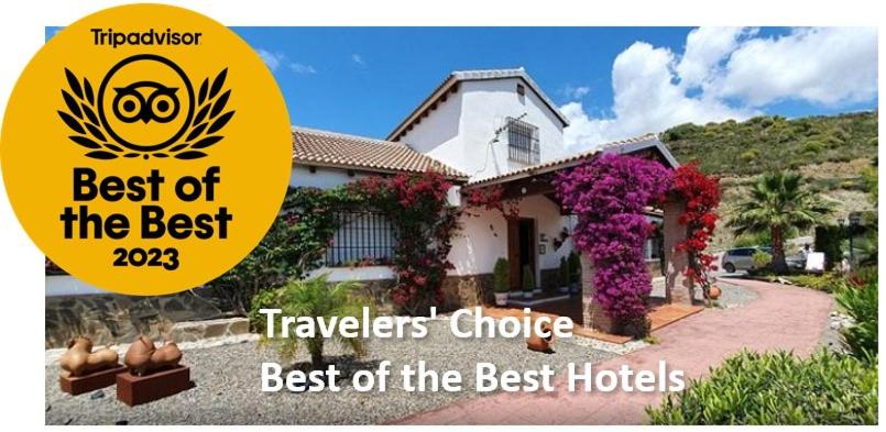 a house with a sign that says travellers choice best of the best hotels at Bed & Breakfast | Guest House Casa Don Carlos in Alhaurín el Grande