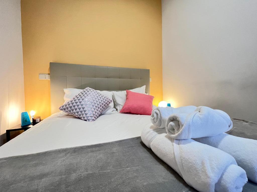 a bedroom with a large bed with towels on it at Encantador Madrid Val Der in Madrid