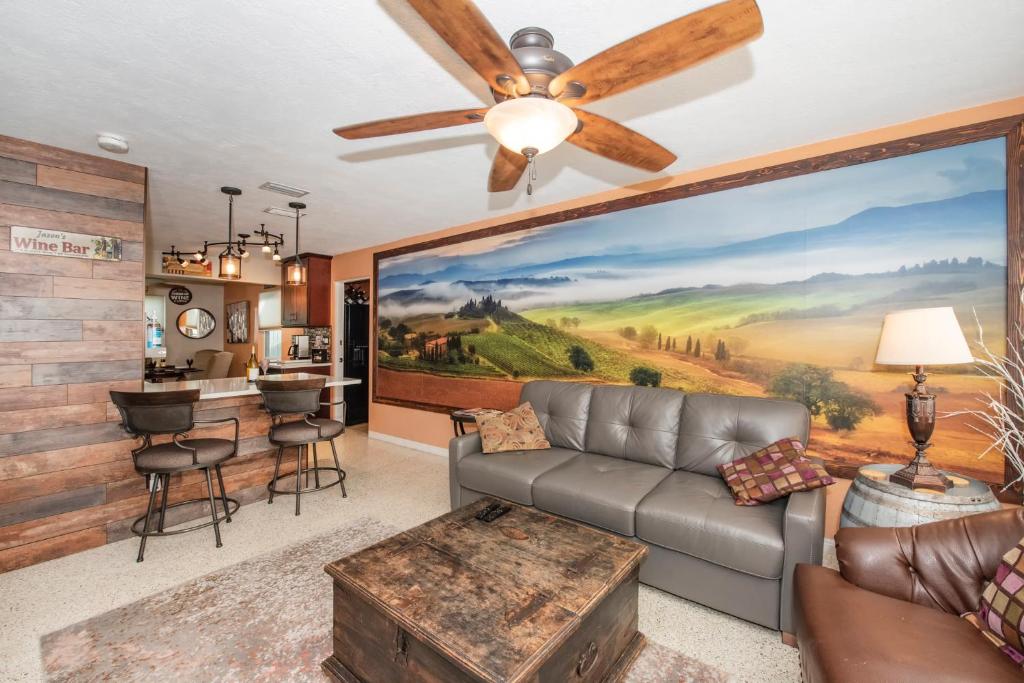 a living room with a large painting on the wall at Gulfport Beach Vacation Rental in St Petersburg