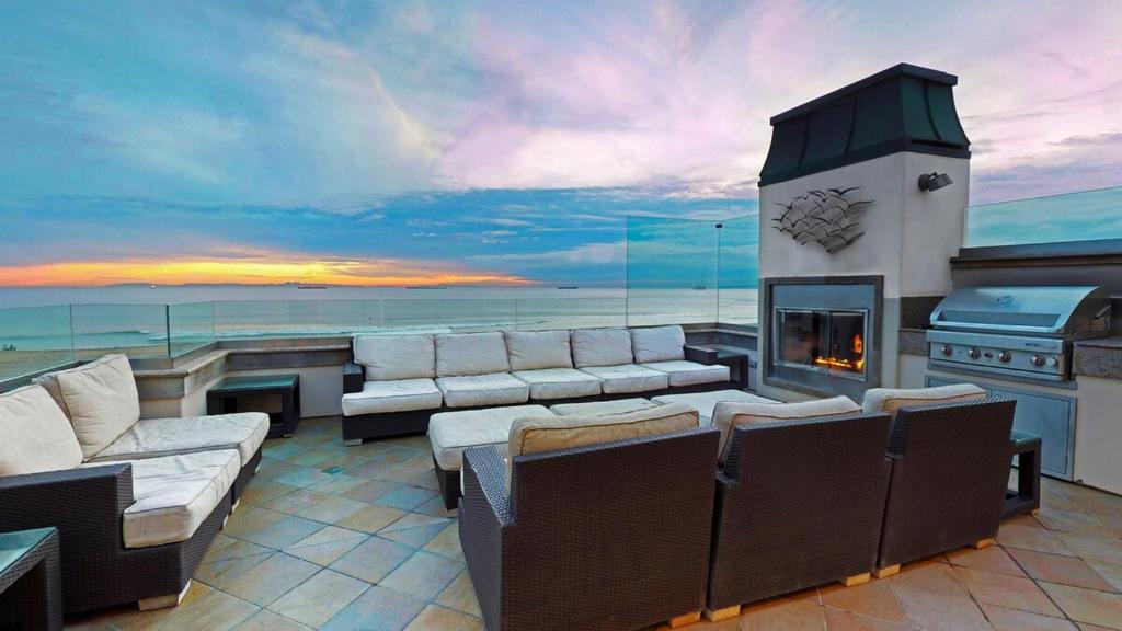 a living room with couches and a fireplace on a yacht at 5 Bedroom Beachfront Masterpiece in Huntington Beach