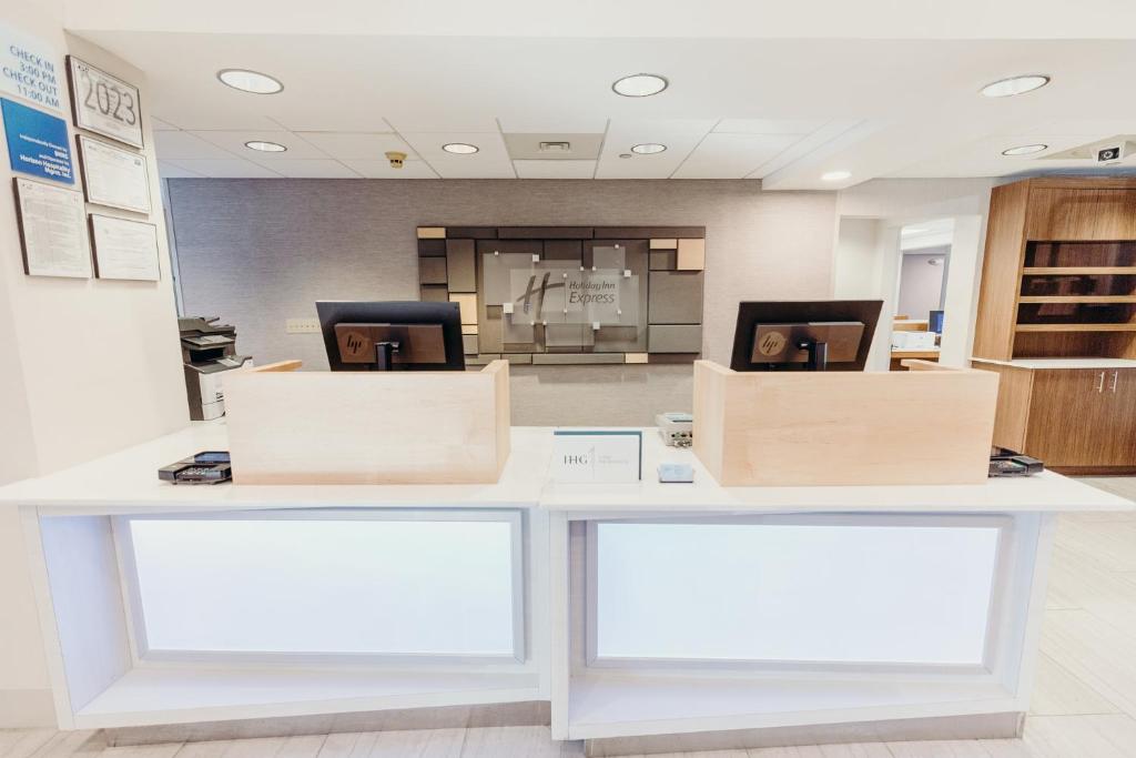 a white counter with two boxes on top of it at Holiday Inn Express Atlanta - Northeast I-85 - Clairmont Road by IHG in Atlanta