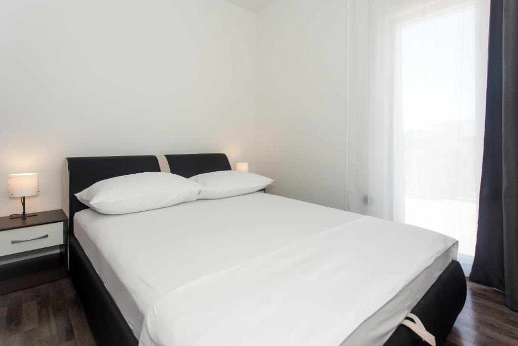 Posteľ alebo postele v izbe v ubytovaní Angolo Apartments