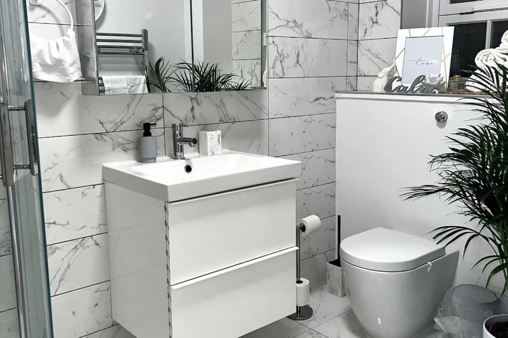 a white bathroom with a sink and a toilet at 2 Bedroom Flat in Vauxhall, London in London