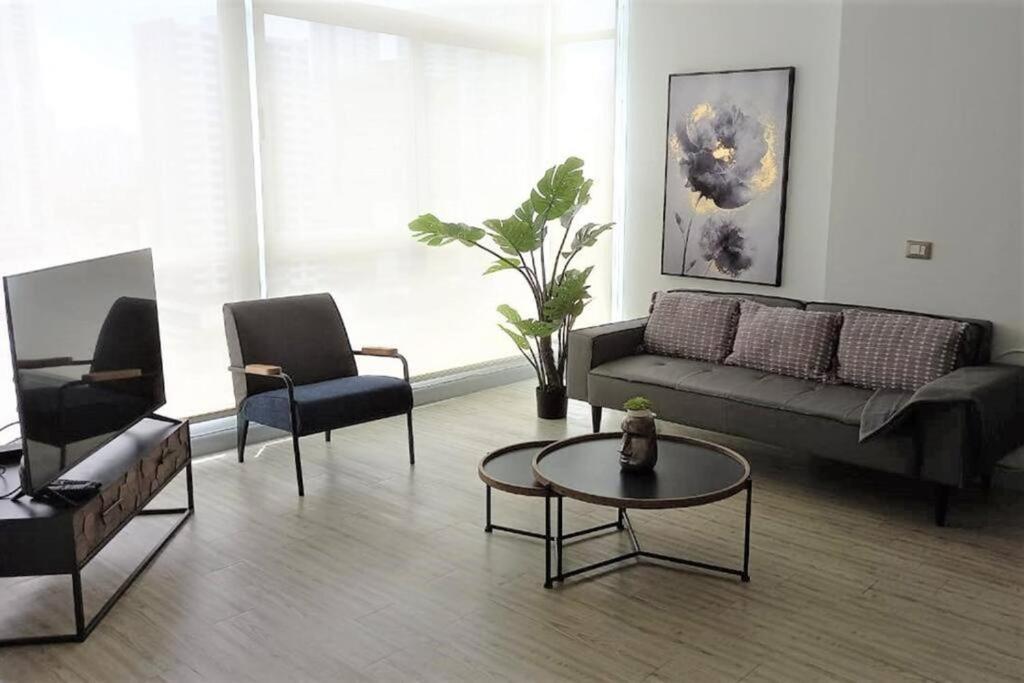 a living room with a couch and chairs and a table at Comfy Apartment City Center - PH Quartier Atlapa in Panama City