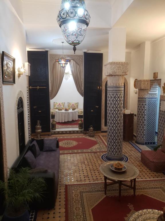 a living room with a couch and a table at Dar Jardin Majorelle Fez in Fez