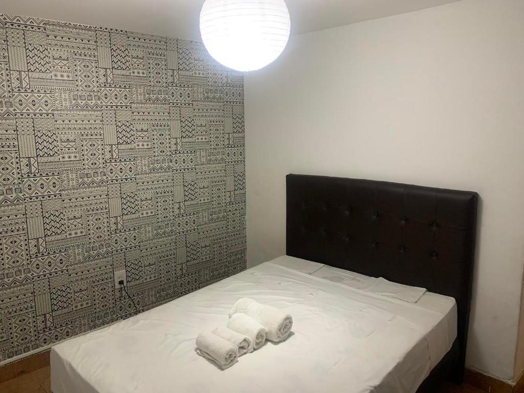 a bedroom with a bed with two towels on it at Cassanova III in San Luis