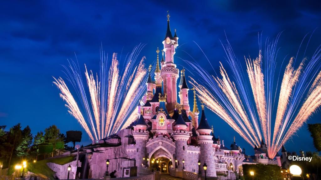 a disney castle at night with fireworks at Villa, Disneyland Paris, vallée village ,Paris ,garden , Syline Home in Serris