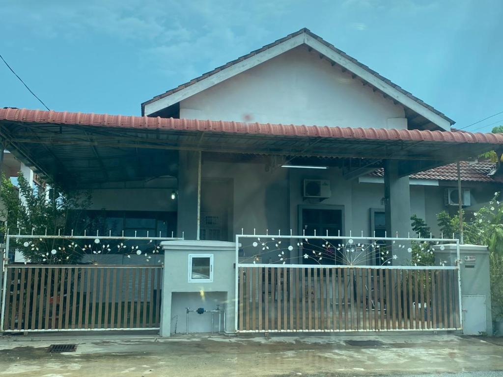 uma casa com um portão em frente em SAHMURA HOMESTAY 1 at GONG BADAK em Kuala Terengganu