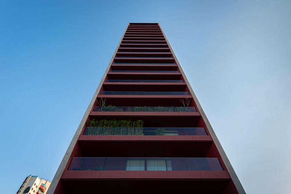 a tall building with a blue sky in the background at Triplo in Sao Paulo