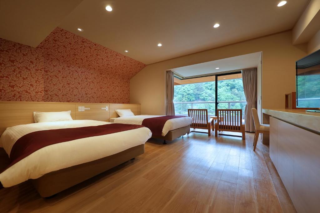 Postel nebo postele na pokoji v ubytování Hotel Sunshine Kinugawa