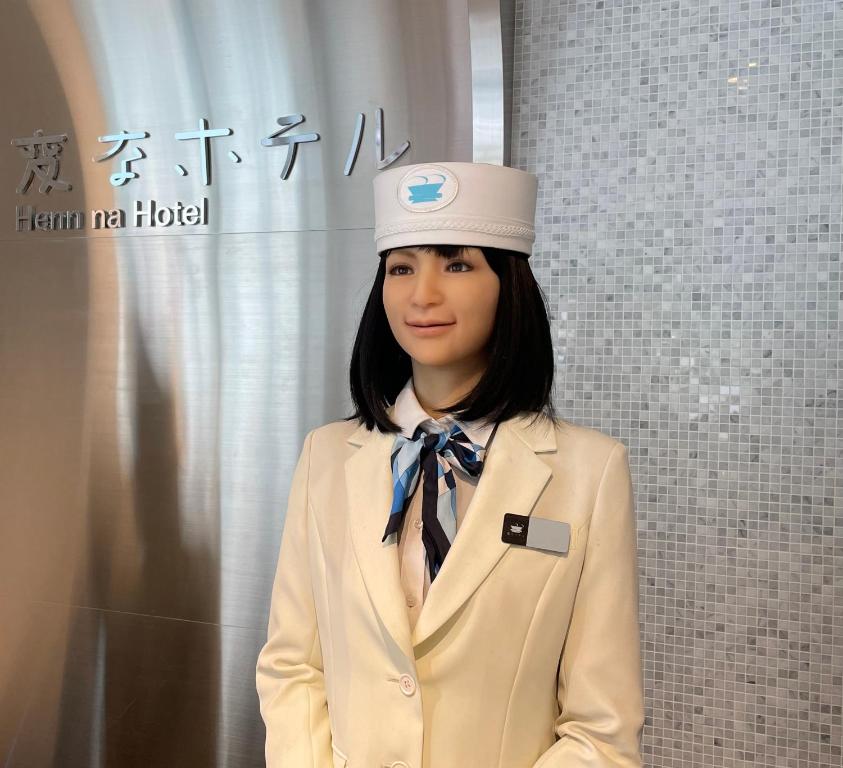 a woman wearing a hat and a suit and tie at Henn na Hotel Tokyo Hamamatsucho in Tokyo