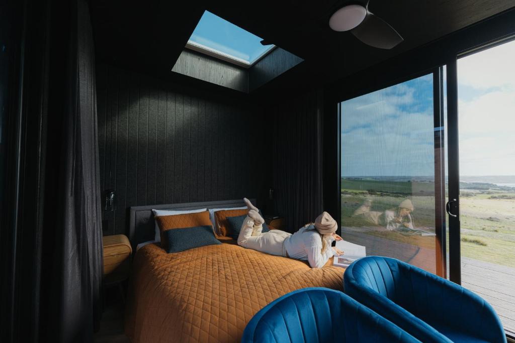 una camera con un grande letto e una finestra di CABN Kangaroo Island a Penneshaw