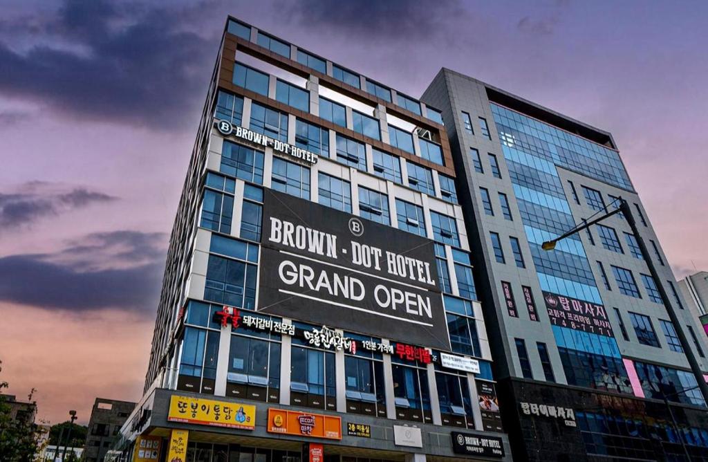 un gran edificio con un cartel en Wonju Brown Dot Hotel Corporate Business, en Wonju