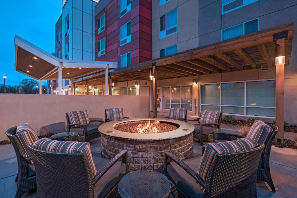 um pátio com cadeiras e uma fogueira em frente a um edifício em TownePlace Suites by Marriott Tacoma Lakewood em Lakewood