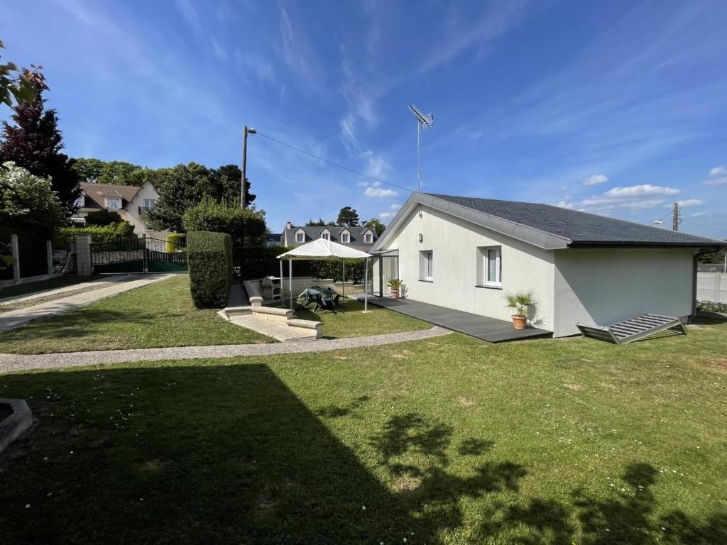 a white house with a grass yard at Maison paisible proche de la plage avec jardin et équipements complets - FR-1-361-491 in Carolles