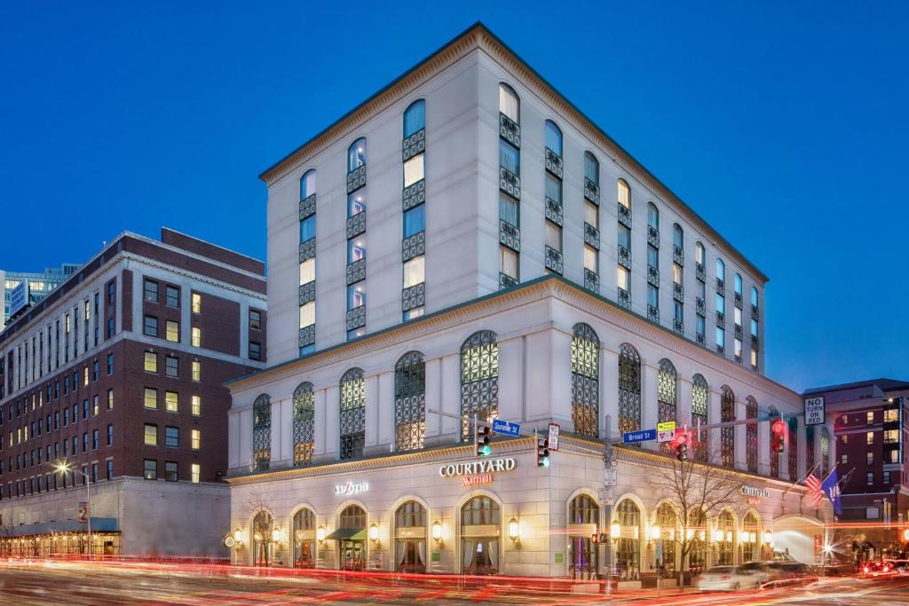 a large white building on the corner of a street at Courtyard by Marriott Stamford Downtown in Stamford