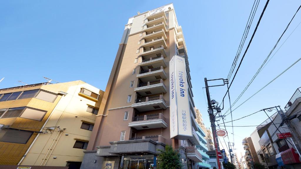 a tall building with a sign in front of it at Toyoko Inn Kawasaki Ekimae Isago in Kawasaki