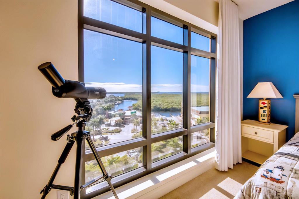 a camera in a room with a large window at Vista Del Mar at Cape Harbour Marina, 10th Floor Luxury Condo, King Bed, Views! in Cape Coral