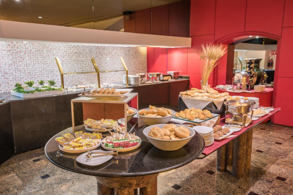 a buffet of food on a table in a restaurant at Holiday Inn Guadalajara Select, an IHG Hotel in Guadalajara