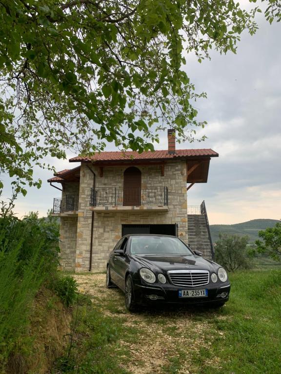 a car parked in front of a house at Villa Shehu in Kuçovë