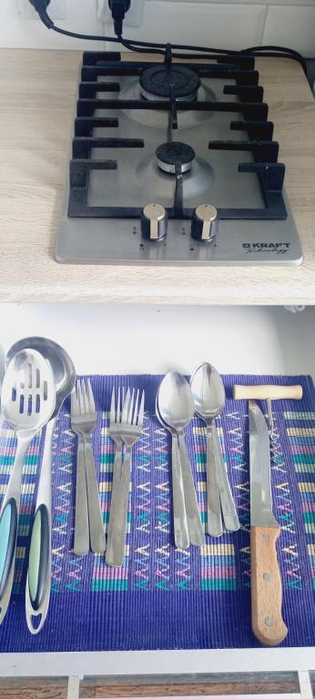 a bunch of utensils are sitting on a shelf next to a stove at микрорайон Астана с кодовым замком in Uralsk