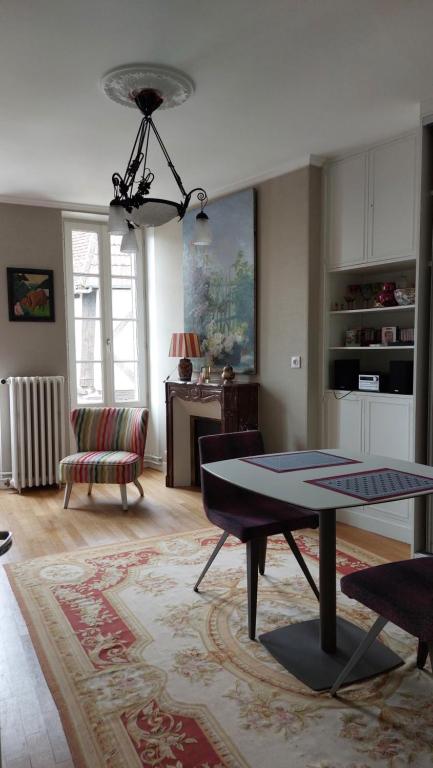 uma sala de estar com uma mesa e um sofá em SUPREMATISME Appartement de Prestige em Vierzon