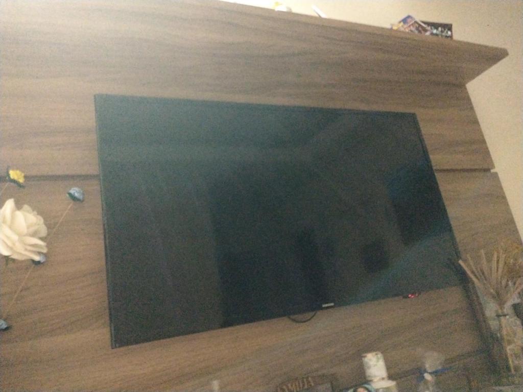 a flat screen tv sitting on top of a wooden floor at Aeroporto in Salvador