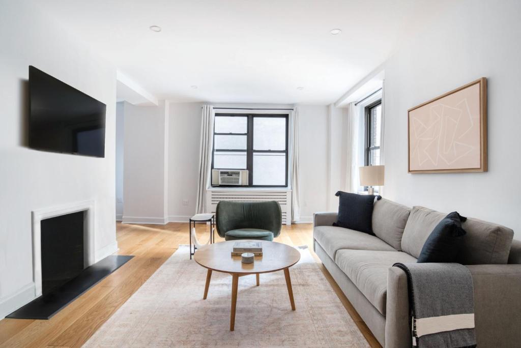 a living room with a couch and a table at Midtown East 2br w gym wd nr Grand Central NYC-1146 in New York