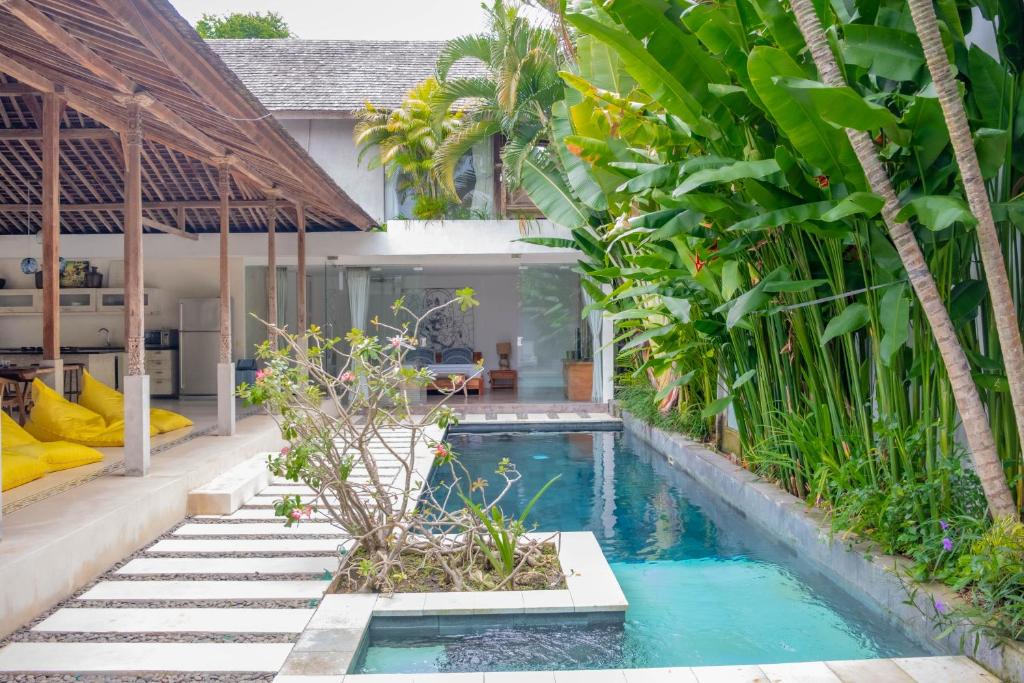 a swimming pool in the backyard of a villa at Villa Marie Clare in Seminyak